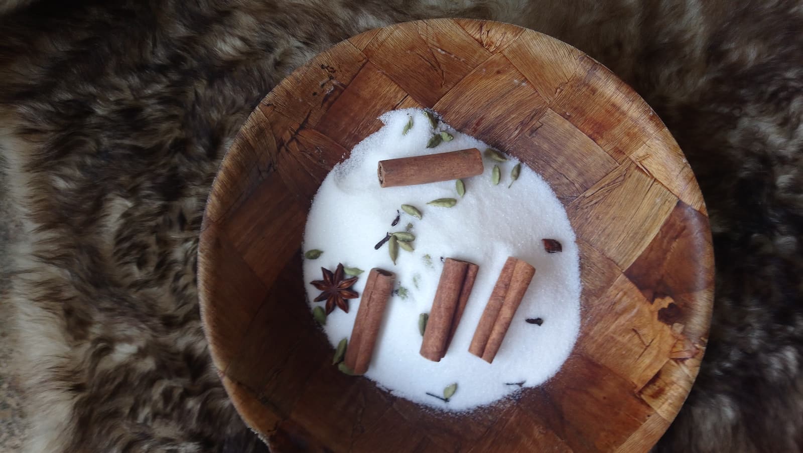 white cigarette butts on round brown wooden ashtray